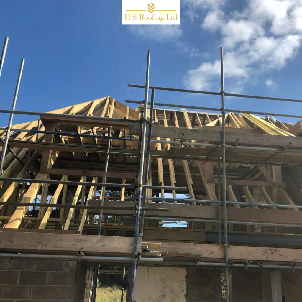 Roof construction in progress with timber framework and scaffolding by HS Roofing Ltd